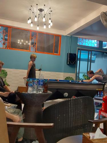 a group of people sitting at tables in a restaurant at Saigon Rooftops Hostel in Ho Chi Minh City