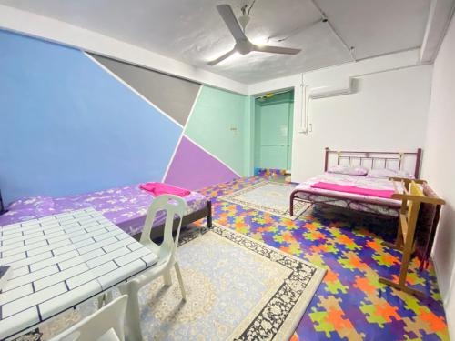 a bedroom with a bed and a colorful floor at MY GUNUNG HOTEL BUDGET in Bachok
