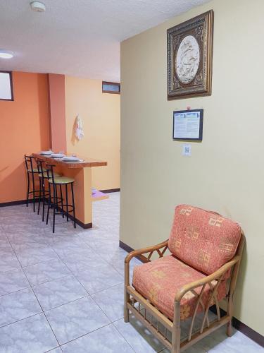 a waiting room with a chair and a table at Moonlight, Galápagos in San Cristobal