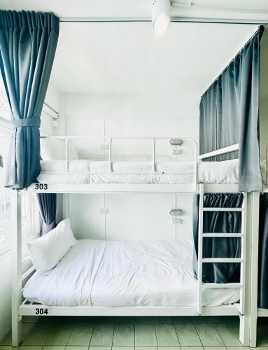 a couple of bunk beds in a room at PICCOLO SUKHUMVIT HOSTEL- Self check-in after 6 pm in Bangkok