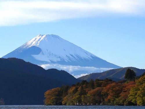 a snow covered mountain in the middle of a lake at Ryuguden in Hakone