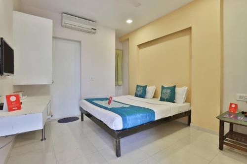 a bedroom with a bed in a room at Hotel Isher International in Gandhinagar