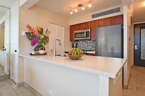 a kitchen with a counter top and a refrigerator at Mahana 602 · MA 602 Kaanapali OceanFront Studio Ocean View Pool in Kahana