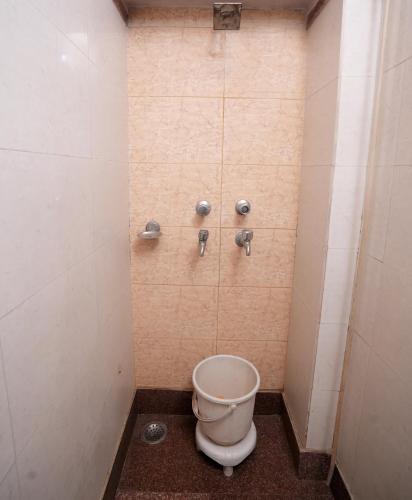 a bathroom with a shower with a toilet in it at New Royal Hotel in New Delhi