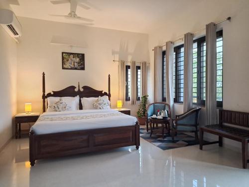 a bedroom with a bed and a table and a chair at Keen Leopard Homestay in Jawāi Bāndh