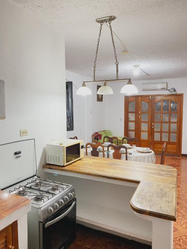 a kitchen with a stove and a microwave on a counter at Moonlight, Galápagos in San Cristobal