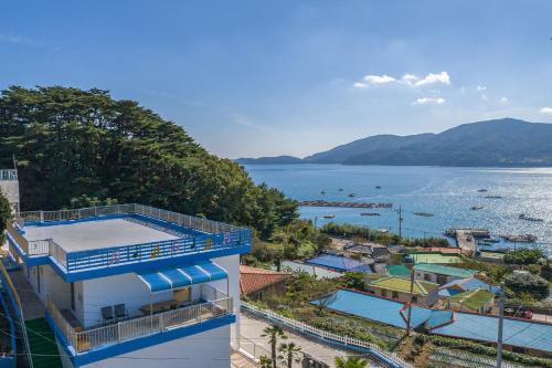 a building with a view of the water at Melodia Pension in Geoje
