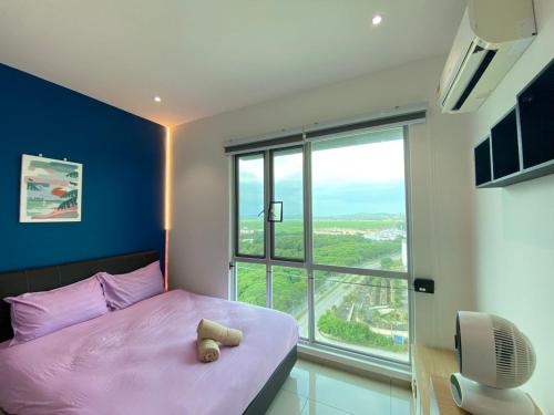 ein Schlafzimmer mit einem rosa Bett und einem großen Fenster in der Unterkunft JOVIAL Modern Cozy Suite `Metropol BM BandarPerda in Bukit Mertajam