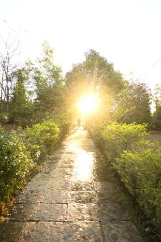 a stone path with the sun shining on it at Z-Bac Adventure & Leisure Resort Kolad in Kolād