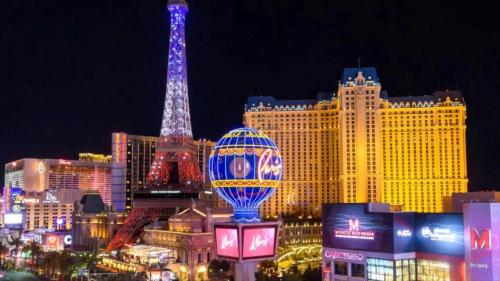 a view of a city with the eiffel tower at night at Paris Las Vegas Resort & Casino in Las Vegas