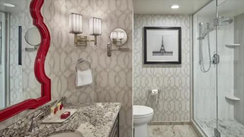 a bathroom with a red mirror and a toilet and a shower at Paris Las Vegas Resort & Casino in Las Vegas