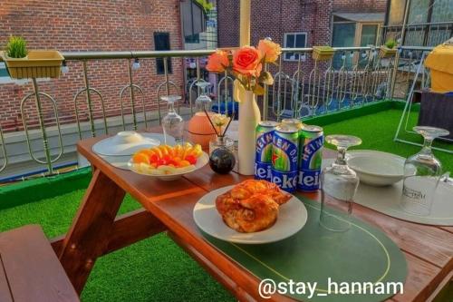 a table with food and drinks on a balcony at Stay Hannam in Seoul
