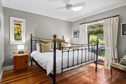 a bedroom with a bed and a window at Lemon Tree Cottage, Kangaroo Valley in Kangaroo Valley