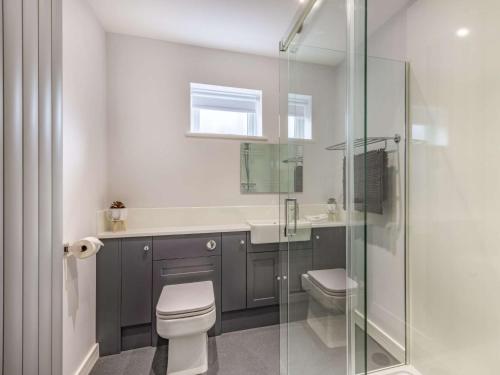 a bathroom with a toilet and a glass shower at 2 Bed in Caister-on-Sea 87689 in Caister-on-Sea