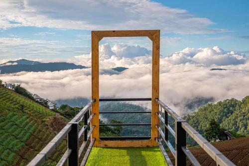 a door to the clouds in the sky on a hill at ภูวินคาเฟ่ โฮมสเตย์ Phuwin Homestay Monjam in Mon Jam