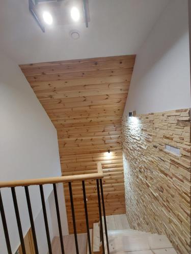 a room with a wooden wall and a staircase at Skalne Rancho - BALIA, MASAŻ in Rabka-Zdroj