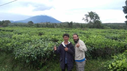 a man and a woman standing in a field at Kutnalek Surf Camp Siberut in Masokut