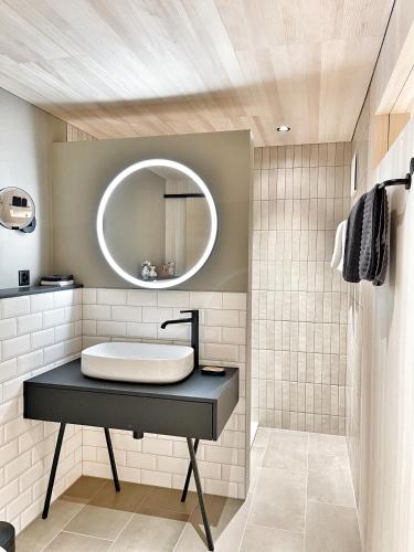 a bathroom with a sink and a mirror at Nanisgarten - Grannys flat in Obergesteln