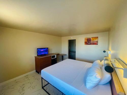 a bedroom with a large bed and a television at Happy Smart Inn I-10 Eloy and Casa Grande in Eloy