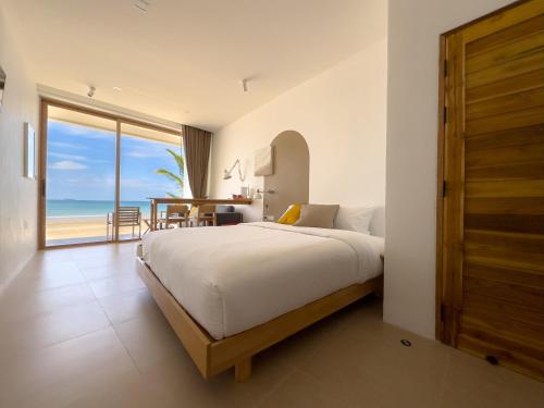 a bedroom with a bed and a view of the ocean at lovelytheroom in Ko Lanta