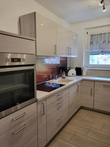 a kitchen with white cabinets and a stove top oven at Exclusivwohnung Hohenmölsen in Hohenmölsen