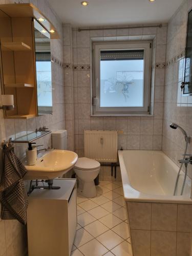 a bathroom with a tub and a toilet and a sink at Exclusivwohnung Hohenmölsen in Hohenmölsen