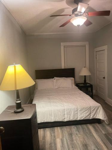 a bedroom with a bed and a ceiling fan at Sherman Hill Des Moines in Des Moines