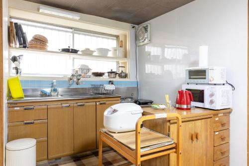 a kitchen with a counter with a toaster and a microwave at アルマス伊王島 in Nagasaki