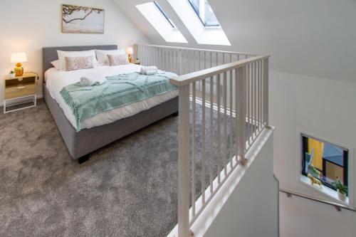 a bedroom with a bed and a stair case at Botanic Bliss Bungalow: 1 bed loft in Christchurch