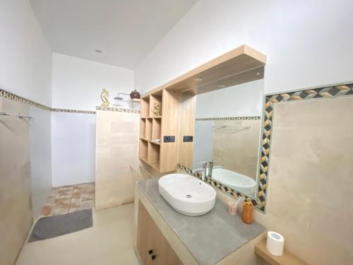 a bathroom with a sink and a mirror at Solaluna Beach Homestay in Amed