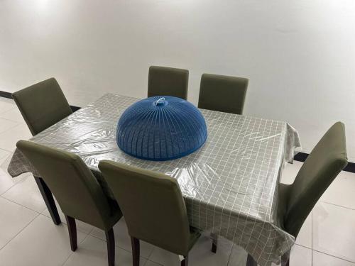 a table with a blue hat on top of it at Home Vacays at Kota Puteri in Batu Arang