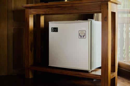 a white refrigerator on a shelf in a room at Anandari Ubud Villa in Ubud