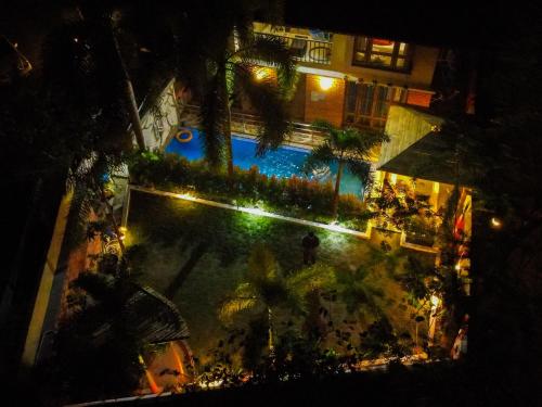 an overhead view of a swimming pool at night at Raichak 3BHK 28ft pool Villa in Raichak