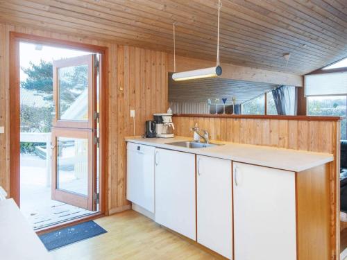 a kitchen with a sink and a counter top at Secluded Retreat with Sauna - By Traum Ferienwohnungen in Sønderby