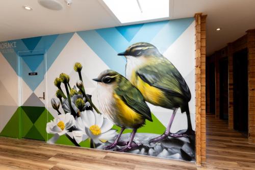 two birds standing in front of a flower mural at Haka House Aoraki Mt Cook in Mount Cook Village