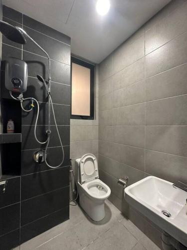 a bathroom with a toilet and a sink at 3 Room/3 Queen Bed, Urban Suite Arcade Room #2carpark in Jelutong