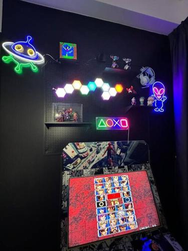 a bedroom with a bed with neon lights on it at 3 Room/3 Queen Bed, Urban Suite Arcade Room #2carpark in Jelutong