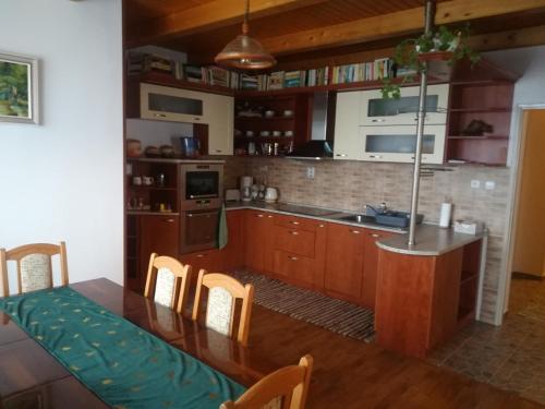 a kitchen with a table and a kitchen with a sink at Apartmán Nina in Oravská Polhora