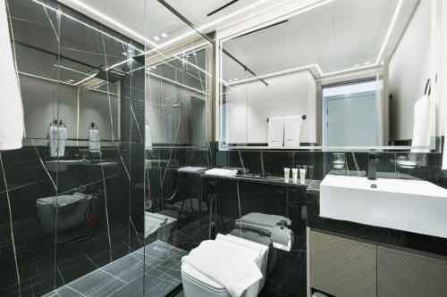 a bathroom with a toilet and a sink and a mirror at Homesgetaway - Ultraluxury 1BR in Binghatti Creek - Al Jaddaf in Dubai