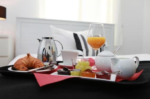 a tray of food and a glass of orange juice at Amical Hotel in Wuppertal