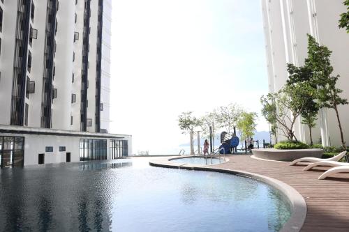 a swimming pool in the middle of a building at The Shore by Homesuite' in Kota Kinabalu