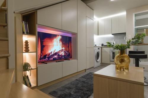 a large living room with a tv on a wall at Green and Grey loft 1 in Alexandroupoli