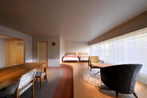 七尾市にあるROOM design hotelのリビングルーム(ダイニングテーブル付)、ベッドルーム1室が備わります。