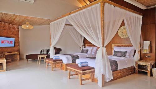 a bedroom with two beds and a tv in it at Vivara Bali Private Pool Villas & Spa Retreat in Jimbaran