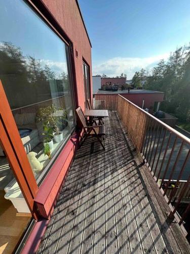 a balcony with a bench on top of a building at Cozy apartment in peaceful area in Petrikyula