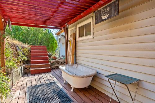 a bath tub sitting on a deck next to a house at Views, Hot Tub, Outdoor Shower, 15m from Sequoia in Three Rivers