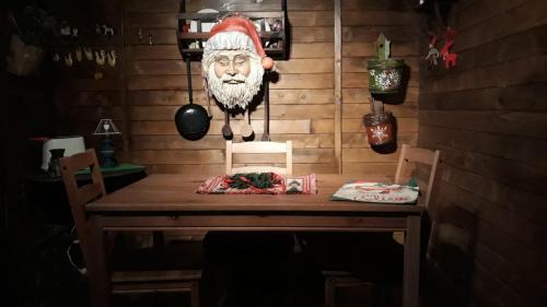 a table with a santa claus head on the wall at Trullo Mauro MGG - Trullo Fragale in Martina Franca