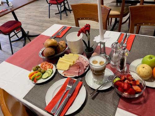 a table with plates of food on top of it at Hotel JÄGERHAUS in Singen am Hohentwiel in Singen