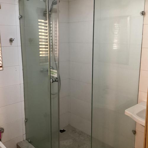 a shower with a glass door in a bathroom at Adis Hotels Ibadan in Ibadan