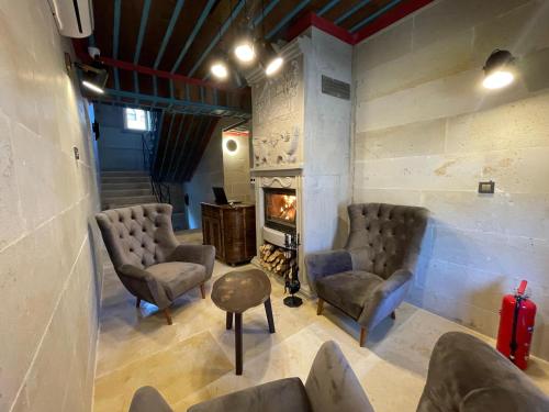 a waiting room with chairs and a fireplace at Leda Stone House in Nevsehir